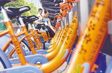 市民在东门口网点探究公共自行车。 记者 刘波 摄 